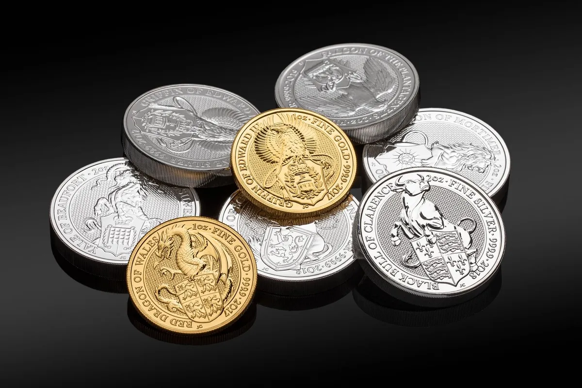Close-up of valuable gold and silver coins with intricate designs, highlighting their worth before selling.