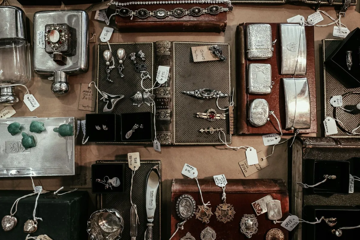 A display featuring vintage jewelry, books, and decorative items, highlighting the appeal of estate sales.